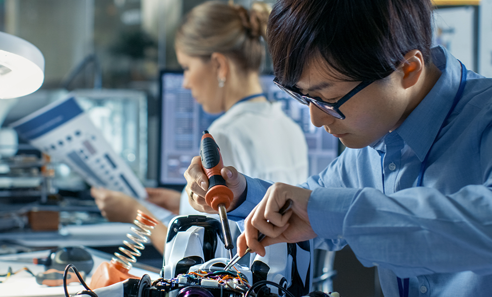 Person working on robotics components