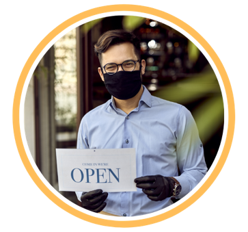 Man with mask holding an "Open" sign